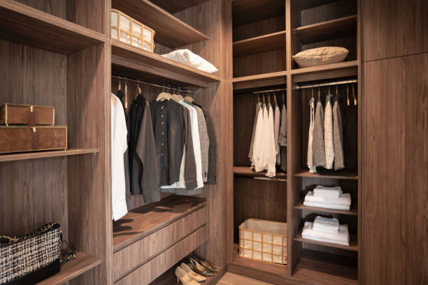 A clean, neutral-toned minimalist wardrobe on a wooden clothing rack